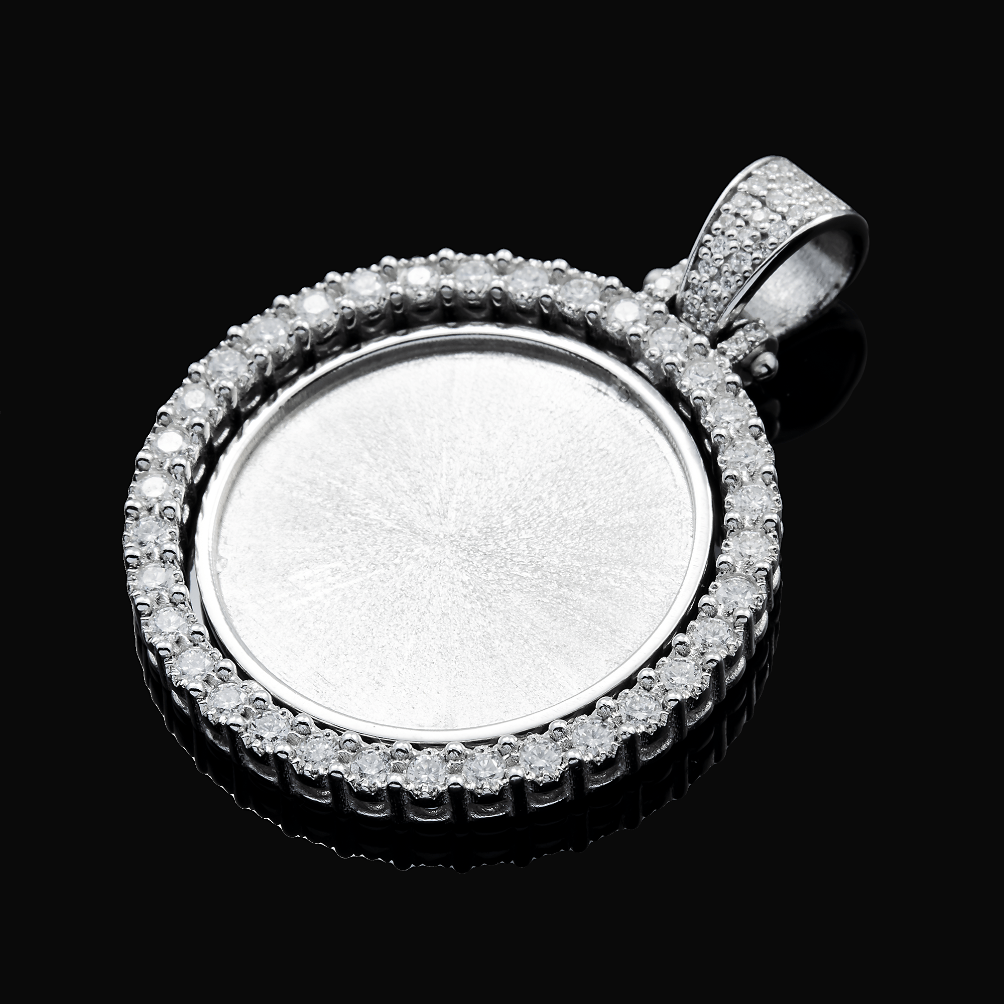 Silver pendant with clear gemstones on a black background