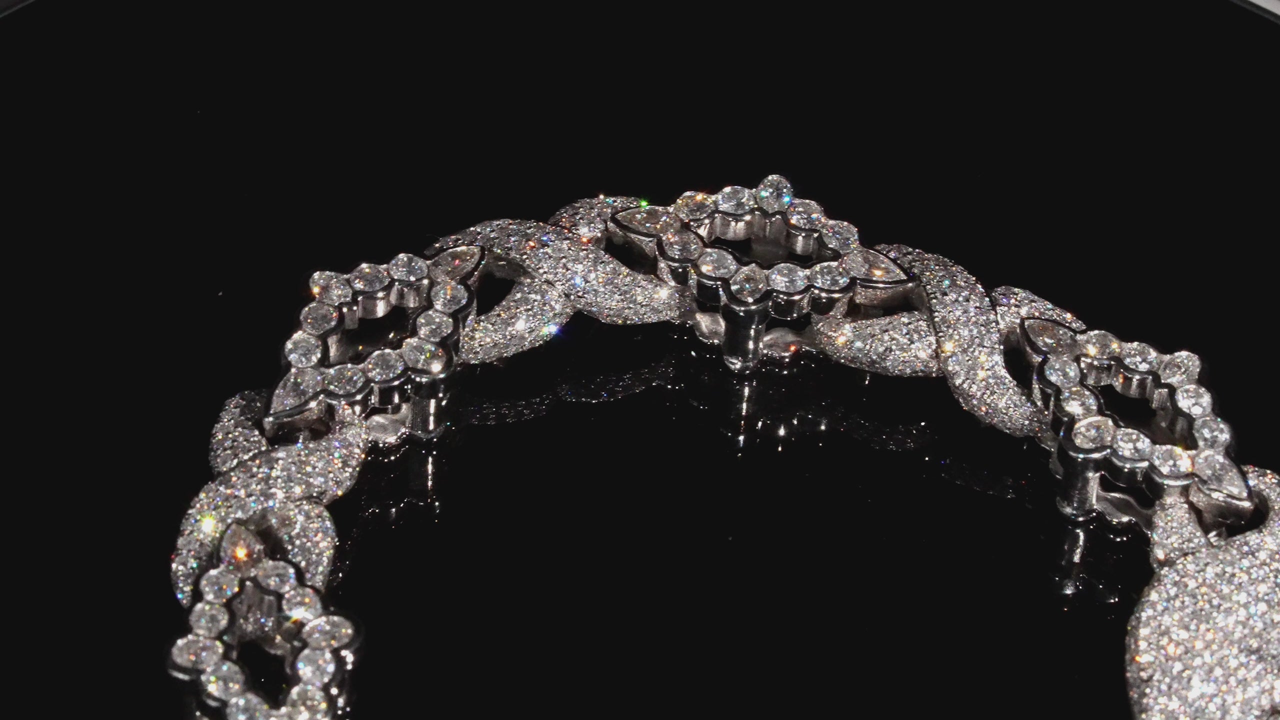 rotating video of a white natural diamond bracelet, rings and watches