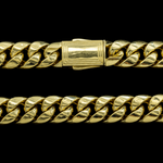 Gold chain bracelet with a clasp on a black background
