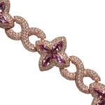 Zoomed in Rose gold bracelet with purple gemstones on a White background