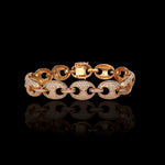 Gold chain bracelet with diamond accents on a black background