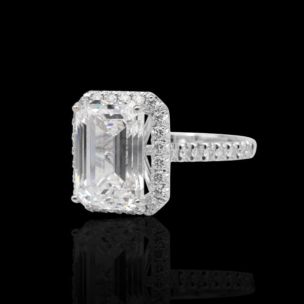 Natural Diamond ring with a rectangular center stone on a black background