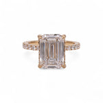 Rose gold ring with emerald-cut diamond on a white background