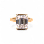 Gold ring with a large rectangular natural diamond on a white background