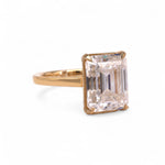 side of Gold ring with a large rectangular diamond on a black background