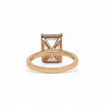 Back of Gold ring with a large rectangular diamond on a black background