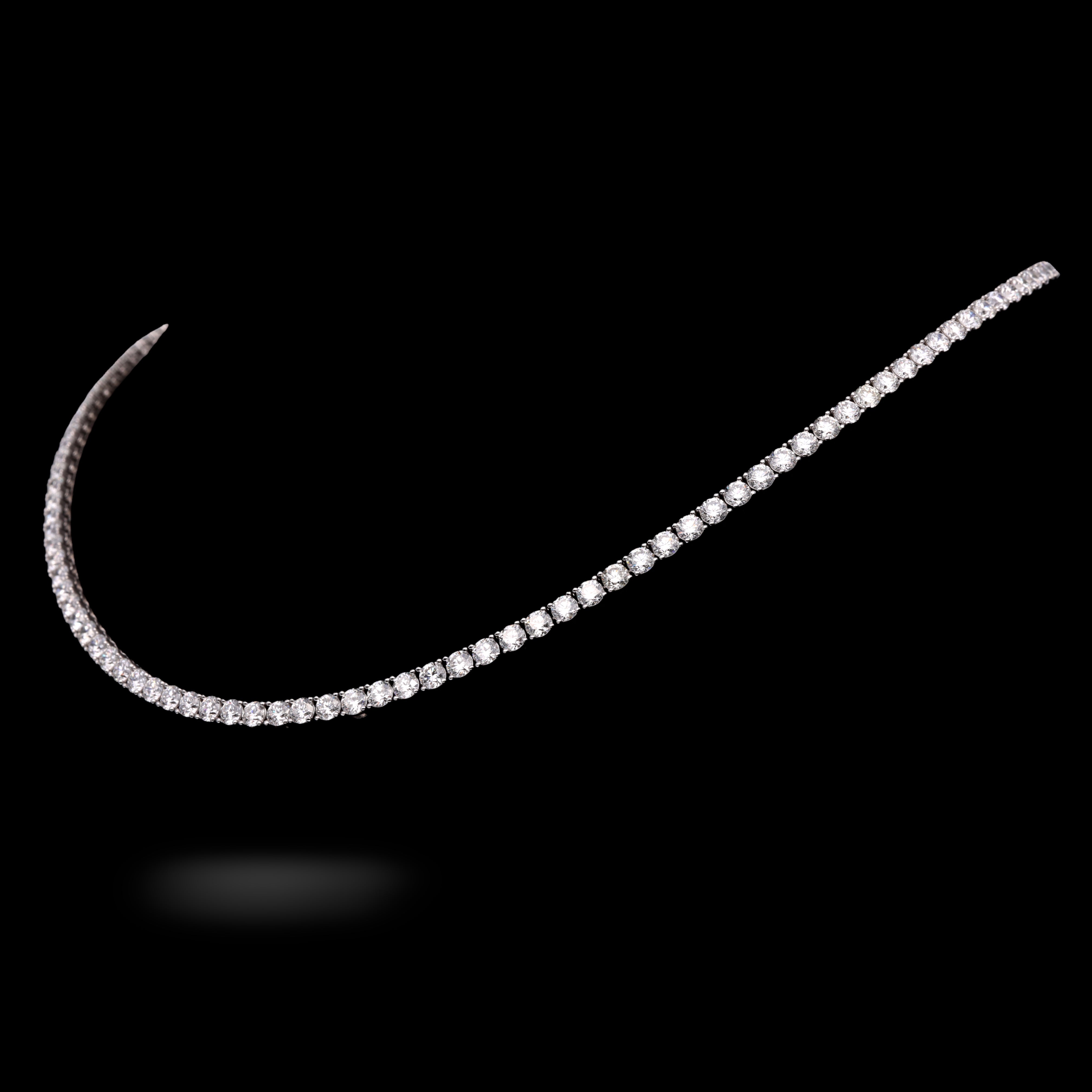 side shot of Diamond necklace on a black background