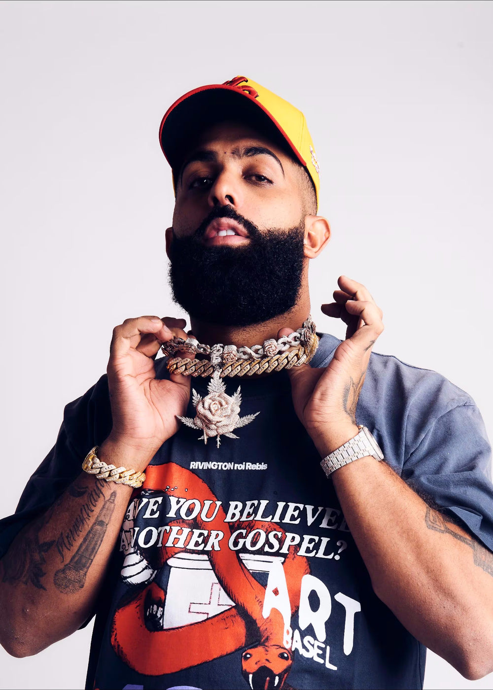 eladio carrion wearing an El Russo & Co Custom made flower pendant