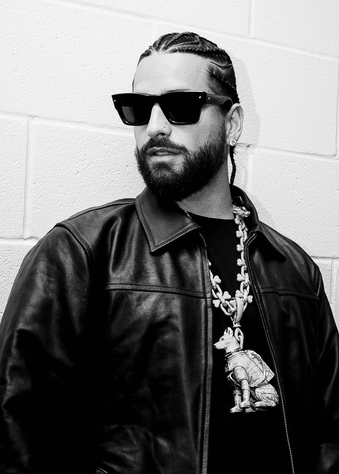 maluma wearing an el russo & co created custom diamond pendant of a spaceship dog