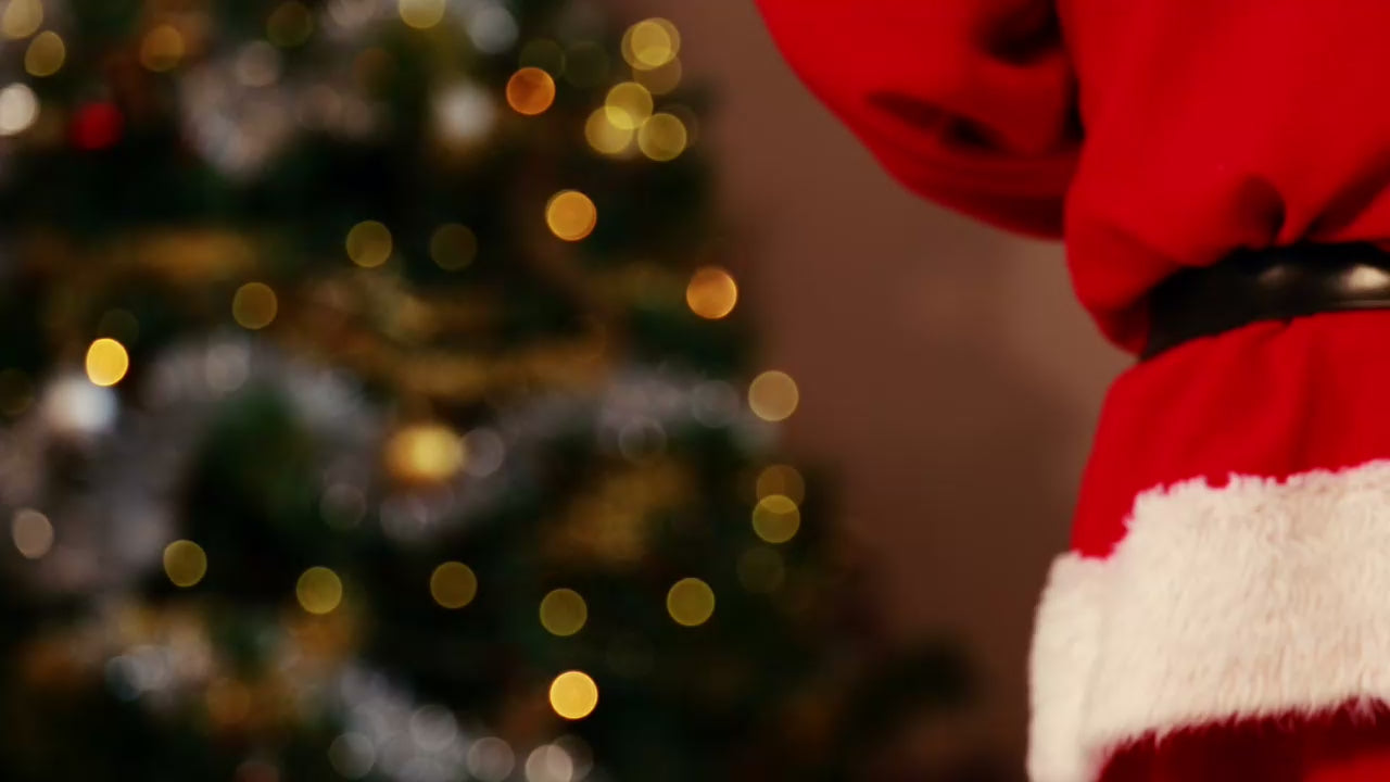 santa clause holding a gift box behind his back